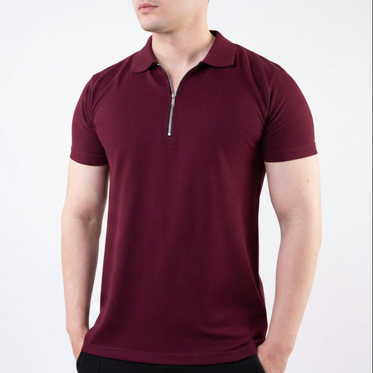 Man wearing a maroon polo shirt with a zipper on a white background