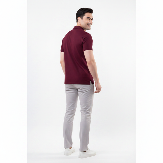 Man wearing a maroon polo shirt and gray pants on a white background Back Side